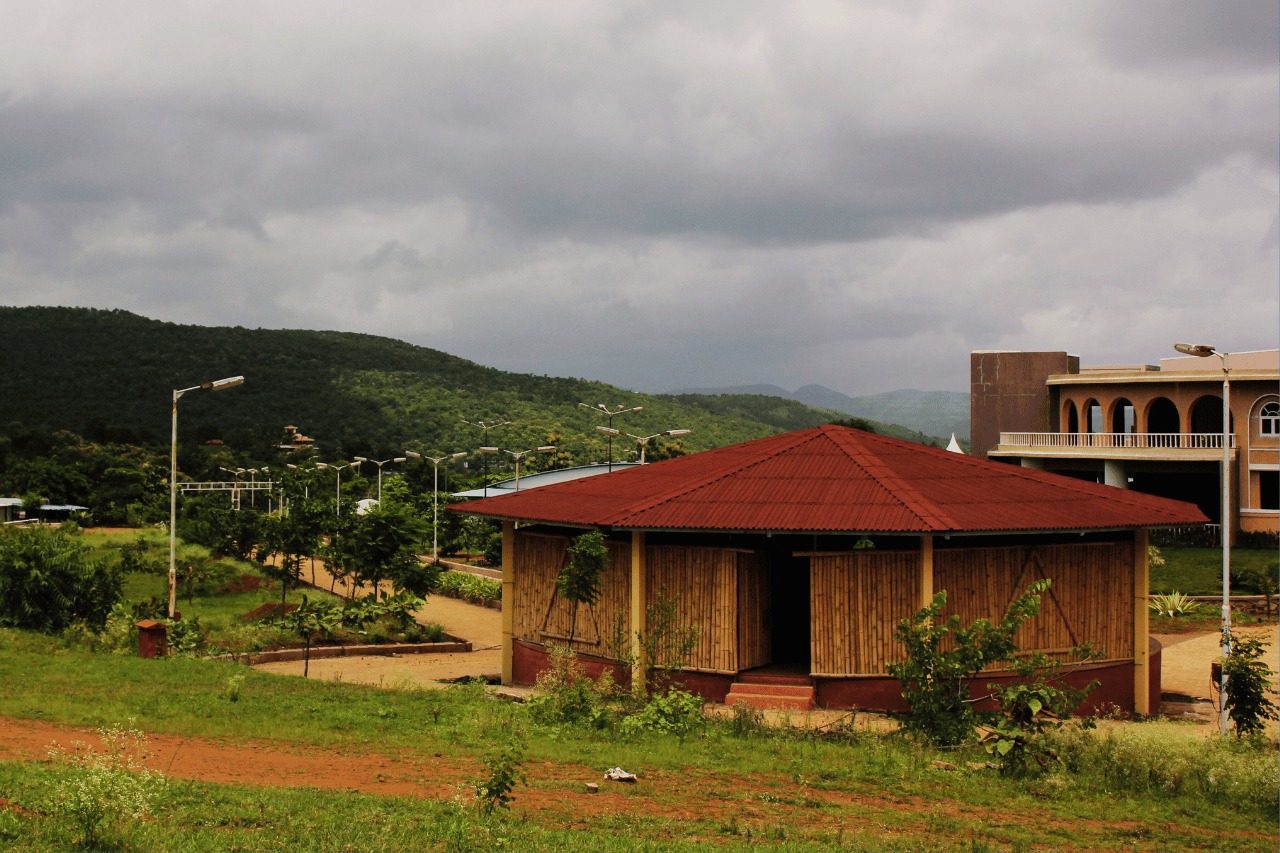 A bamboo pavilion on the campus with the hills beyond